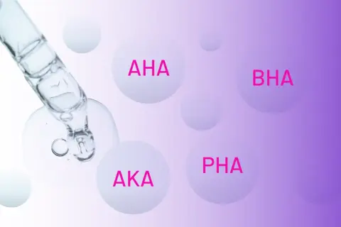 Kropla serum z pipety zawiera różne rodzaje kwasów: AHA, BHA, AKA i PHA.