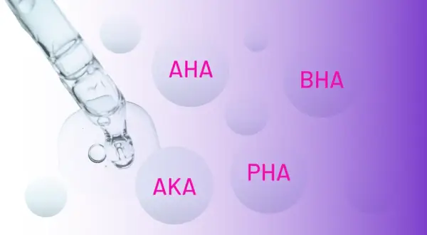 Kropla serum z pipety zawiera różne rodzaje kwasów: AHA, BHA, AKA i PHA.